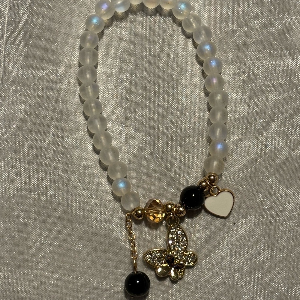 Elegant Gold and Black Beaded Bracelet with Butterfly Charm